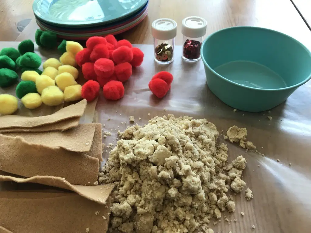 Apple Cloud Dough with felt strips and pom poms for sensory play. Part of letter A and apple preschool theme.