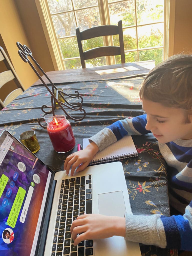 Boy playing on homeschool writing game.
